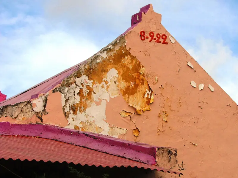 Peeling pink gable with the date 1922 painted on it, Aruba