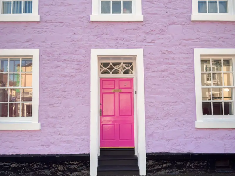 Pink door in a lilac wall in Kirkcudbright, Scotland